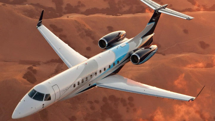 Commercial airplane flying over a desert landscape