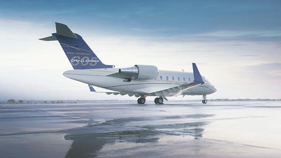 Private jet on a runway with a clear sky background